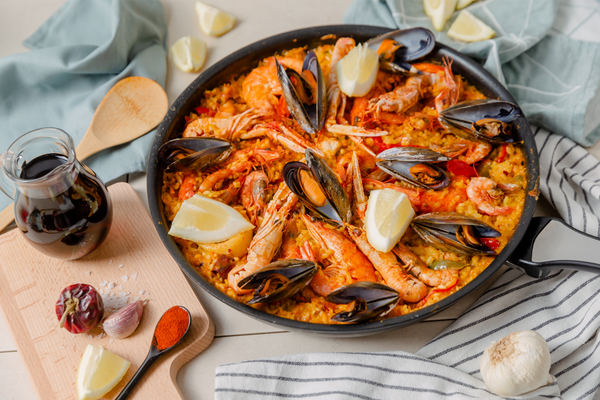 A delicious paella dish with bomba rice, fresh mussels and shellfish prepared on a table for Easter