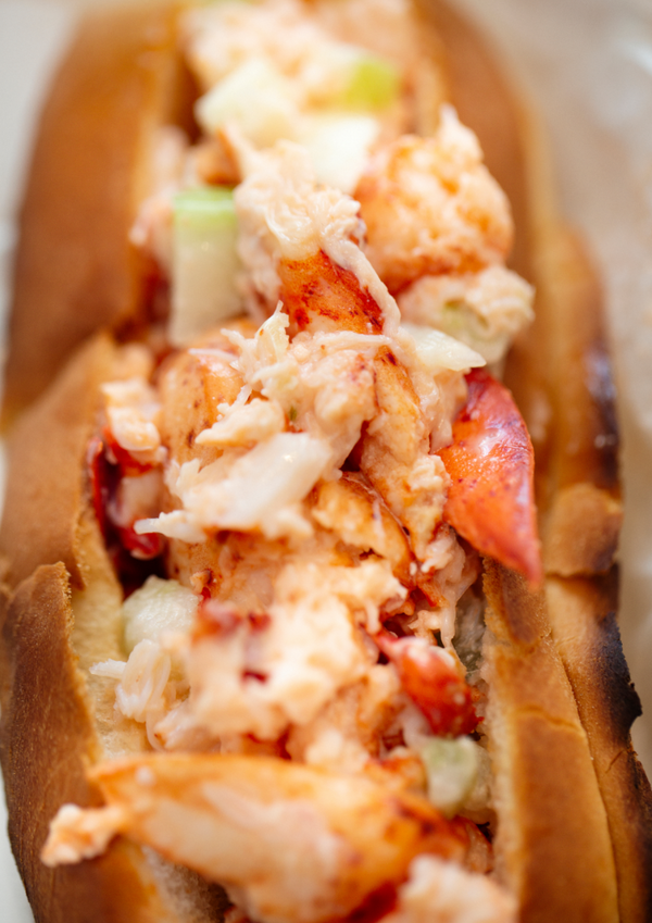 Homemade lobster roll with crispy bun and chopped chives