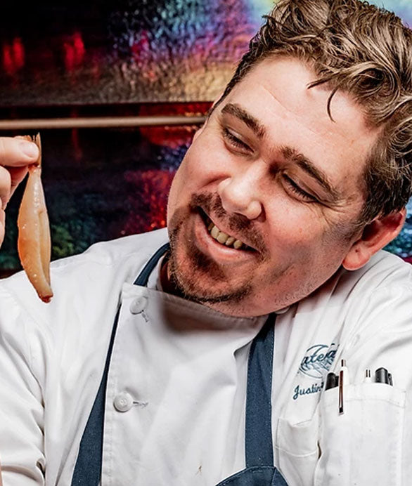 chef smiling admiring blowfish tails