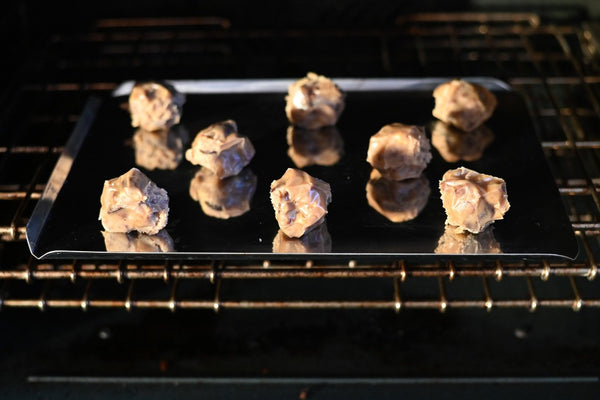 cochon volant cookies on a baking sheet in the oven