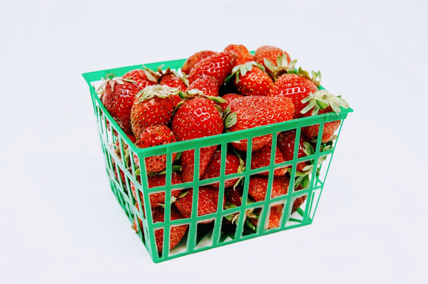 red strawberries in a green basket